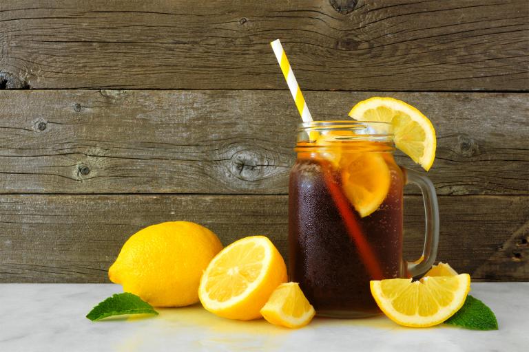 a jar full of iced tea with lemons