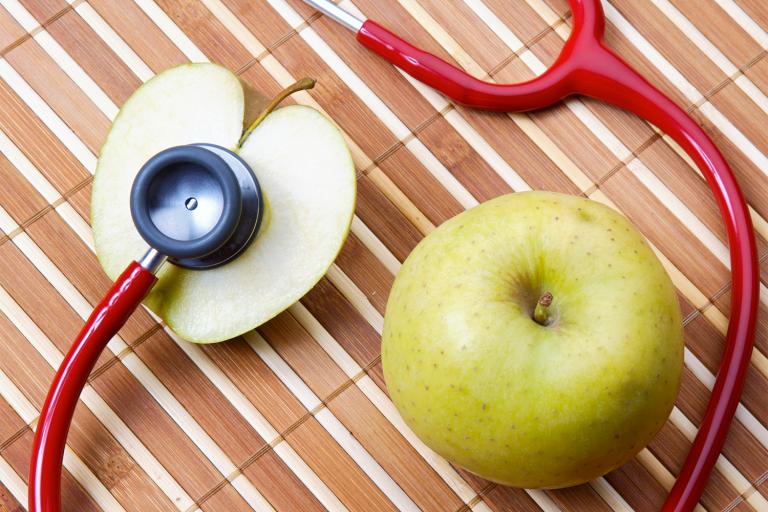 an apple and a stethoscope